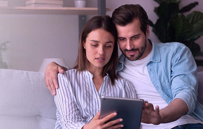 Couple reading Femasys content on a tablet
